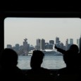 Travel Photo Thursday: Downtown Vancouver by Seabus The past weekend I went to Las Vegas for a bachelor party. Now that we have rapid tranist to the airport via the Canada Line nearly all of my solo flights start at Lonsdale Quay in North Vancouver with a ride on Vancouver's SeaBus. Carrying my new Swissgear Sling camera bag, when I saw the shot of downtown Vancouver's skyline nicely framed by the Seabus window I was able to get the shot.